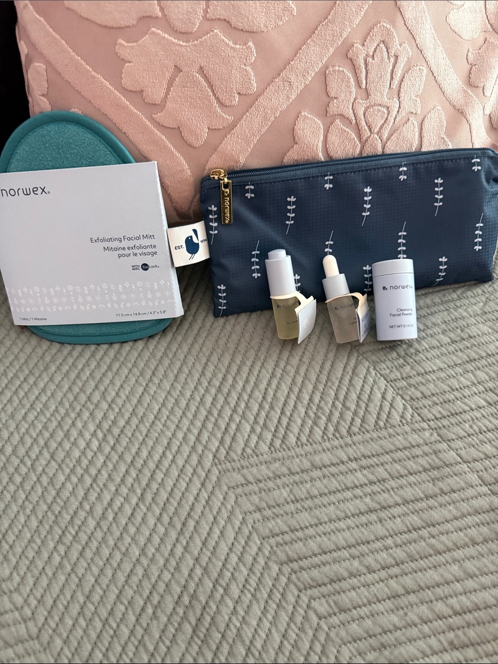 Norwex Navy Botanical Zip Pouch with Teal Exfoliating Mitt and Skincare Samples